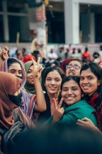 Group of women celebrating on the streets of Cumilla, Bangladesh, showcasing vibrant expressions and joy.