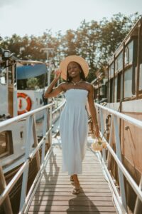 Charming portrait of a woman in a sunhat walking on a dock in Lille, France.